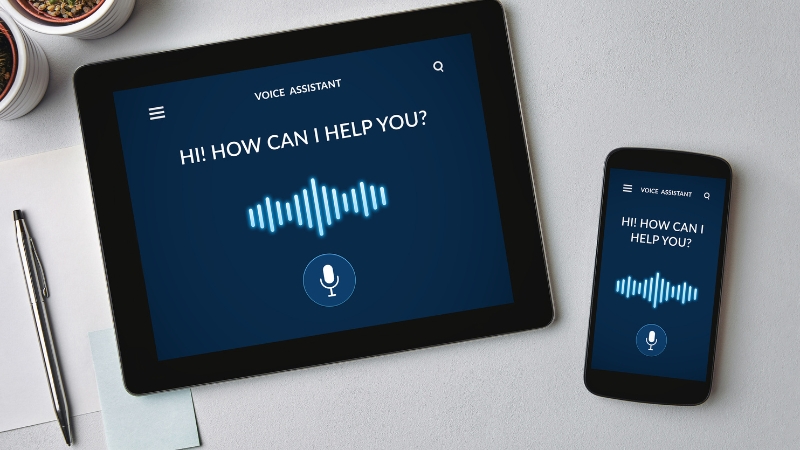 A tablet and smartphone show a voice assistant screen